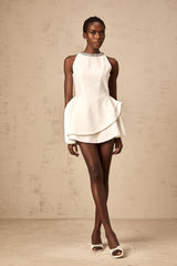 A short white mini dress with crystal embellishments and layered design featuring Denise style