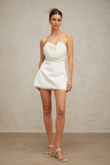 A short white mini dress with floral applique details named Lucie