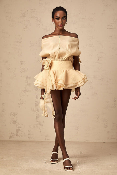 A short white mini dress with floral appliques and ruffled flounces featuring a feminine Amelie style design