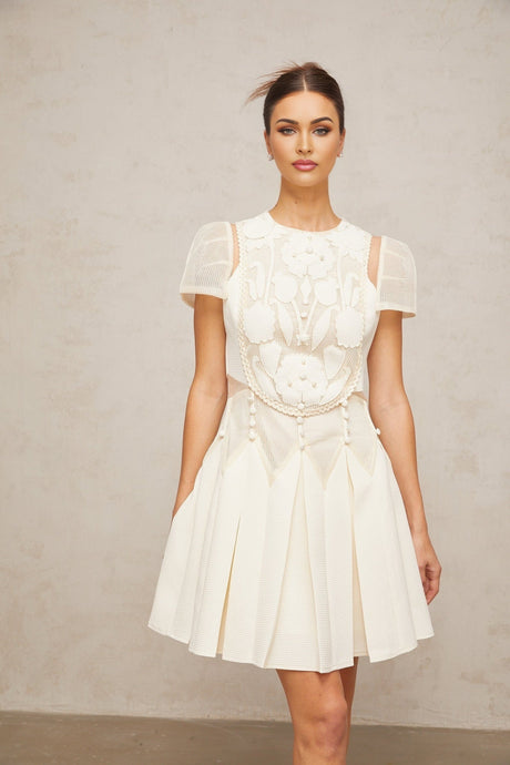 A short white mini dress with floral embroidery details