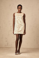 A short white mini dress with intricate embroidery and bead embellishments decorating the fabric named Isabelle