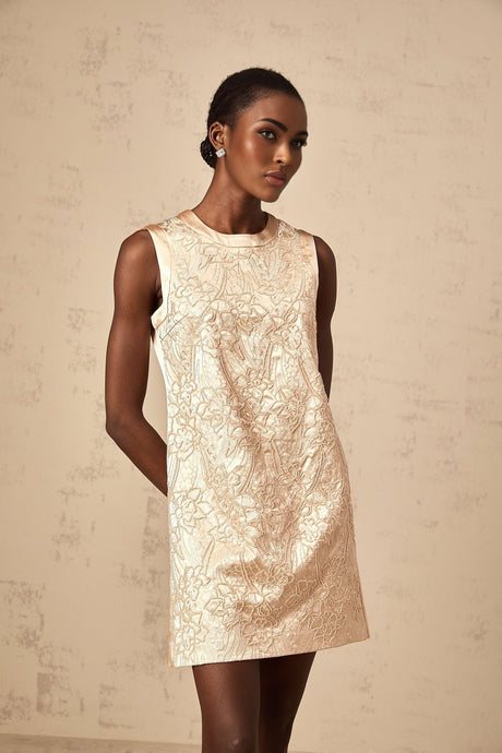 A short white mini dress with intricate embroidery and beaded embellishments adorning the fabric