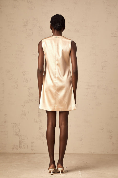 A short white mini dress with intricate embroidery and beaded embellishments featuring a fitted silhouette and delicate design details