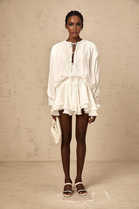 A short white mini dress with pleated fabric and glitter effect named Mahault featuring a sleeveless design and flared skirt