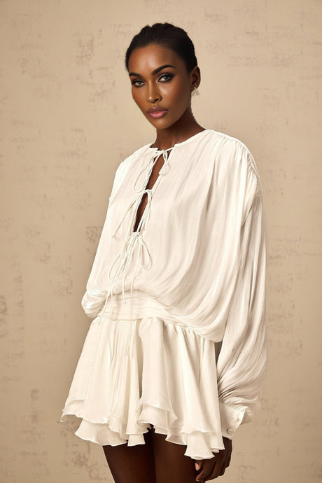 A short white mini dress with pleated fabric and glitter effect named Mahault featuring a sleeveless design and flared skirt
