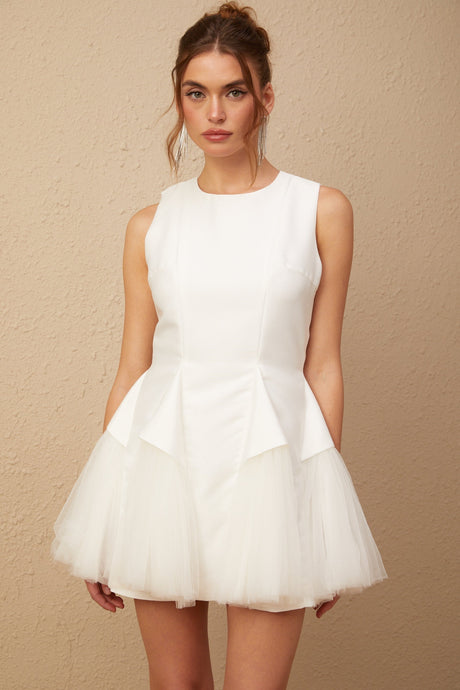 A short white mini dress with puff sleeves and tulle panels featuring a fitted bodice and flared skirt