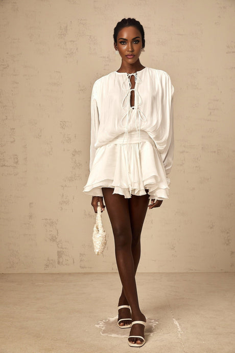 A short white pleated mini dress with a glittery shimmering effect named Mahault
