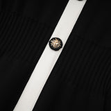 A short wool dress with colorblocked design and ribbed knit texture featuring a mini length and called the Charlotte dress