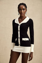 A short wool dress with ribbed knit texture featuring color blocks in different shades worn by a model against a plain background