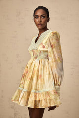 A short yellow mini dress with lace panels and a floral print pattern named Olivia