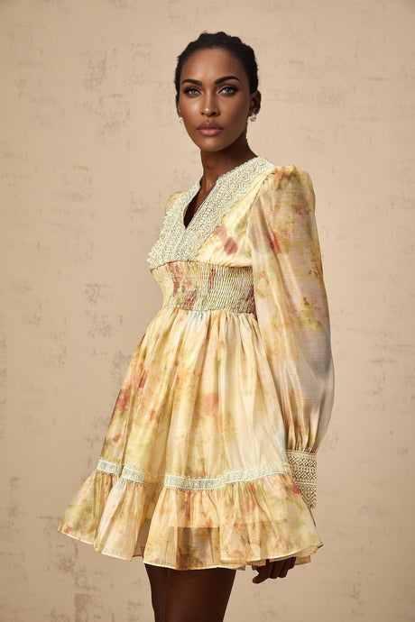 A short yellow mini dress with lace panels and a floral print pattern named Olivia