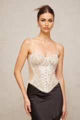 A sleeveless bustier top with floral lace paneling named Karine featuring a structured bodice and romantic design elements