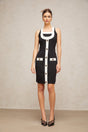 A sleeveless knit mini dress with a halter neckline featuring color blocks in different shades The dress has a form fitting silhouette and falls above the knee