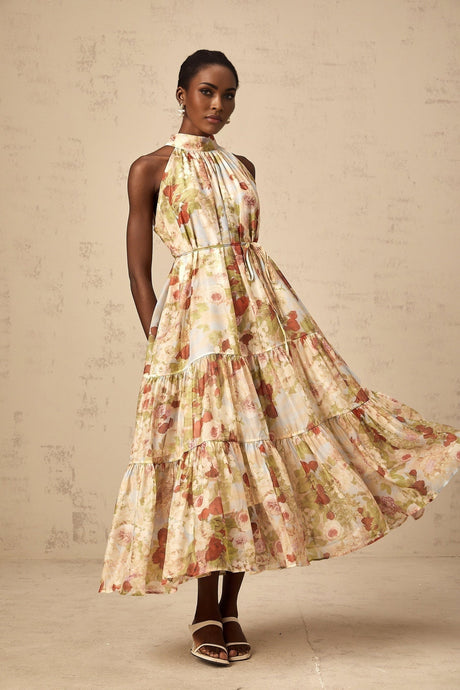 A sleeveless midi dress with a floral print in neutral colors