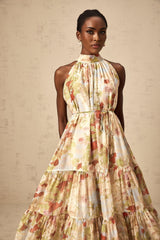 A sleeveless midi dress with a floral print in neutral colors
