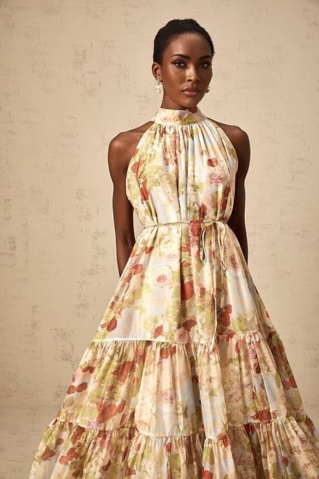 A sleeveless midi dress with a floral print in neutral colors