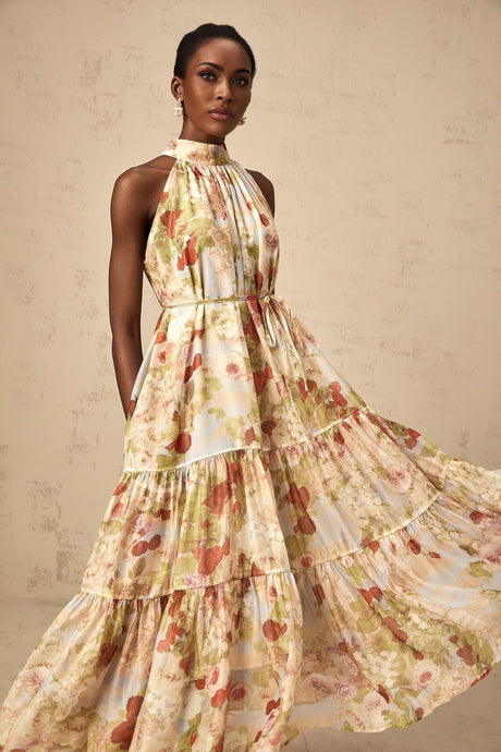 A sleeveless midi dress with a floral print pattern in neutral colors