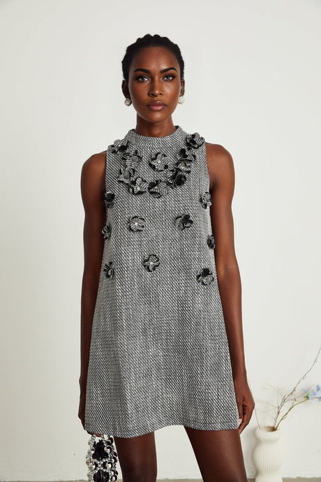 A sleeveless mini dress with a floral pattern featuring faux flowers called Nadege