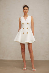 A sleeveless mini dress with a pleated peplum hem named Elise featuring a fitted bodice and flared skirt