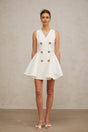 A sleeveless mini dress with pleated details and a peplum hem named Elise