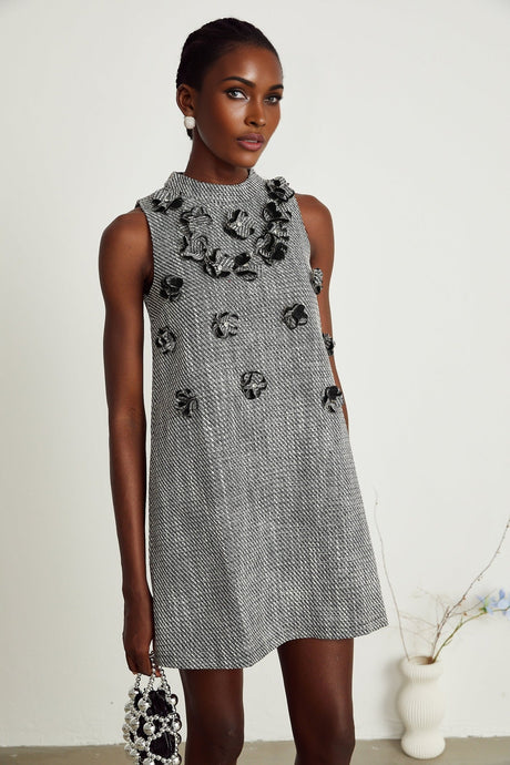 A sleeveless mini dress with vibrant faux flowers printed on the fabric featuring a floral pattern inspired design by Nadege