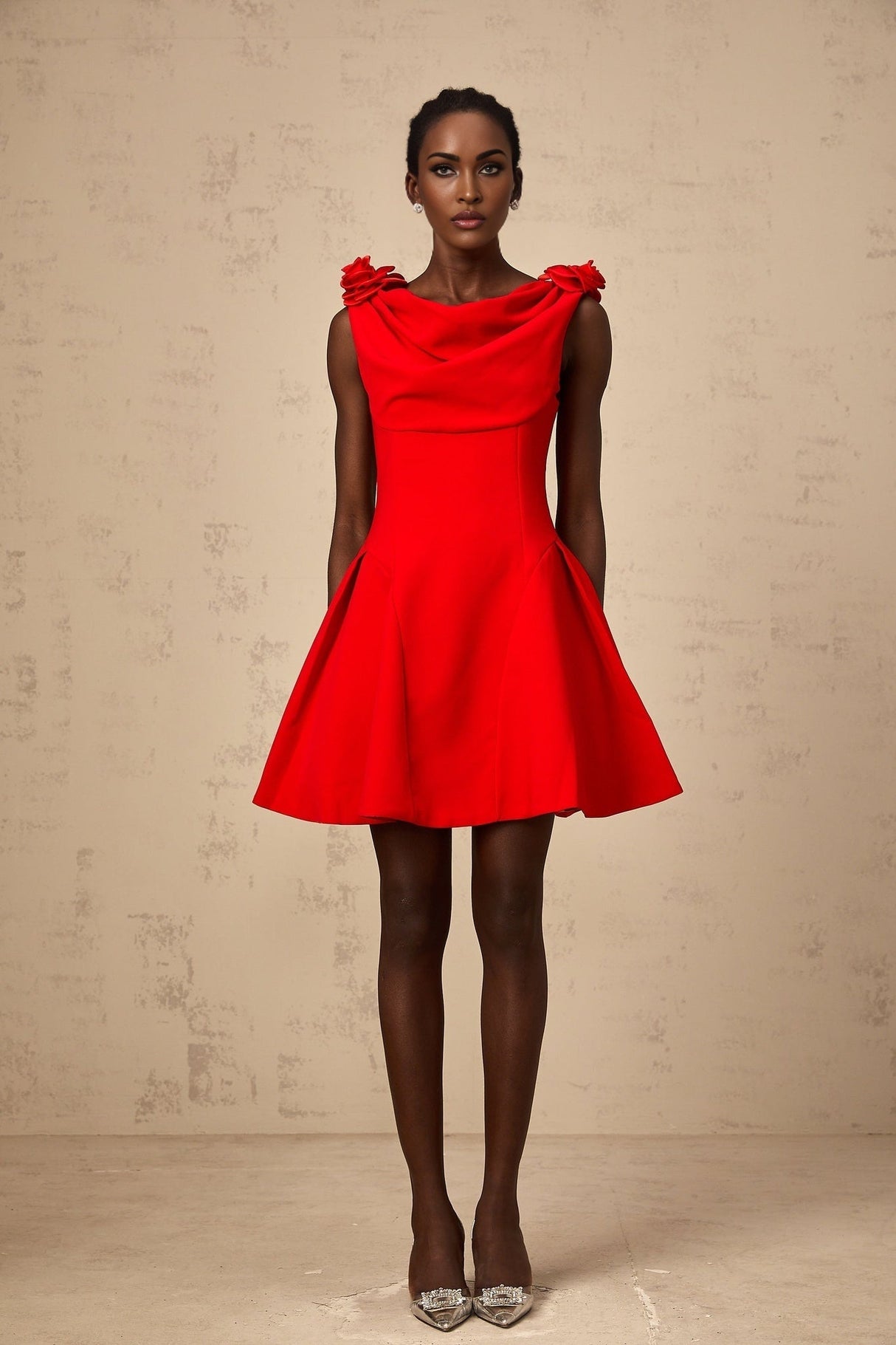 A sleeveless red mini dress with faux flower details on a mannequin or model against a plain background