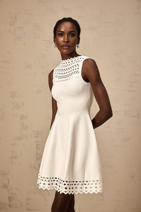 A sleeveless white knitted mini dress with cutout details featuring a formfitting silhouette and a short hemline