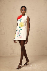 A sleeveless white mini dress with raised three dimensional petal details covering the fabric