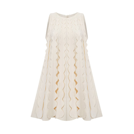 A sleeveless white mini dress with wavy details and a fitted silhouette named Axelle