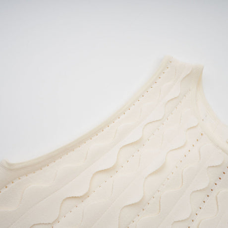 A sleeveless white mini dress with wavy details called Axelle