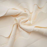 A sleeveless white mini dress with wavy details called Axelle