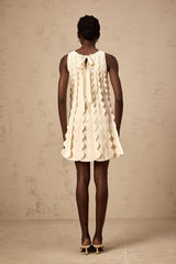 A sleeveless white mini dress with wavy details named Axelle