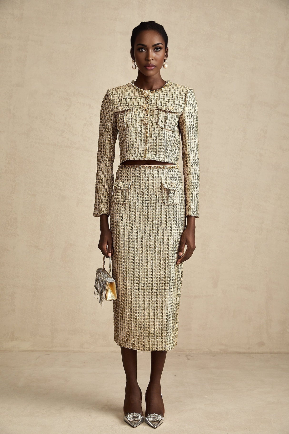 A stylish gold tweed jacket and skirt set with sequin embellishments featuring a matching ensemble for an elegant look