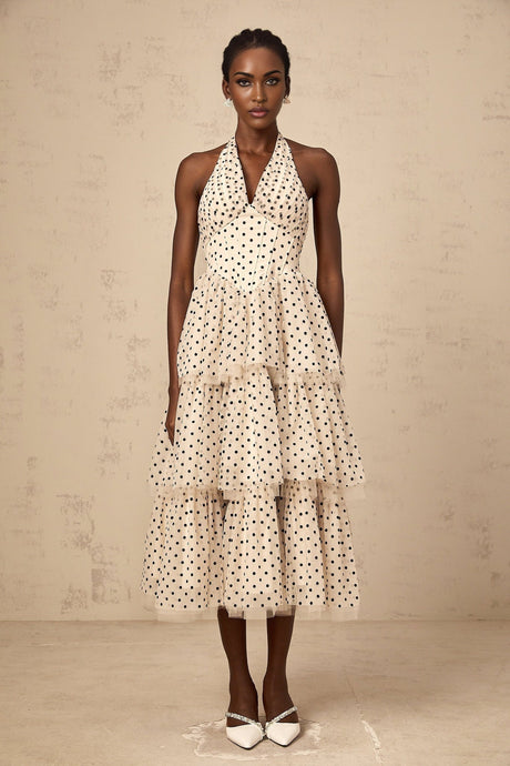 A tiered midi dress in ivory color with polka dot pattern named Philae featuring multiple layers in the skirt