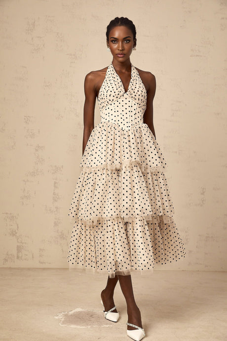 A tiered midi dress in ivory fabric with polka dot pattern featuring multiple layers and a flowy silhouette
