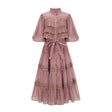 A tiered midi dress with lace cutouts featuring a light and airy design in white or cream color with intricate patterns and a flowy silhouette