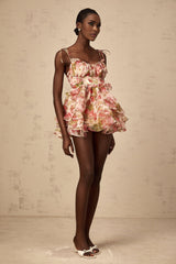 A tiered mini dress with a strawberry print pattern featuring a design inspired by Angele