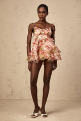 A tiered mini dress with a strawberry print pattern featuring a design inspired by Angele