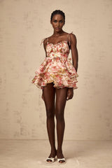 A tiered mini dress with a strawberry print pattern featuring a design inspired by Angele