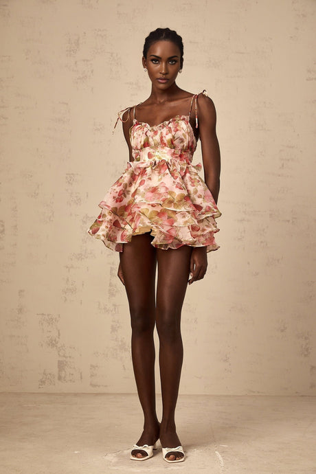 A tiered mini dress with a strawberry print pattern featuring a design inspired by Angele