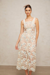 A white Aline midi dress with floral lace pattern featuring a fitted bodice and flared skirt