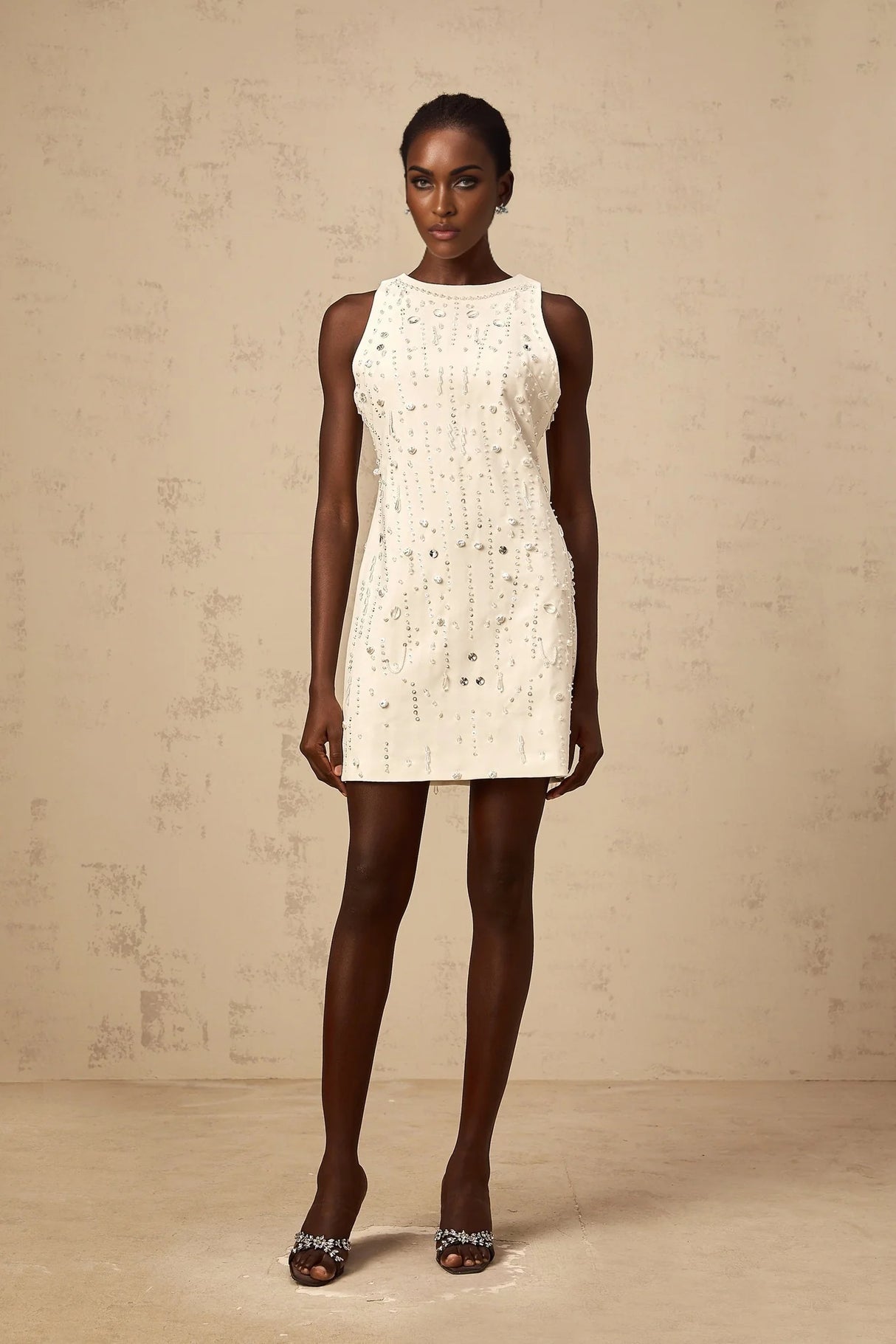 A white Aline mini dress with embellishments named Flavie
