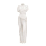 A white asymmetric maxi dress with pleated details and a flowing silhouette named Catherine