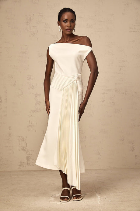 A white asymmetric midi dress with draped detailing featuring a unique silhouette and flowing fabric