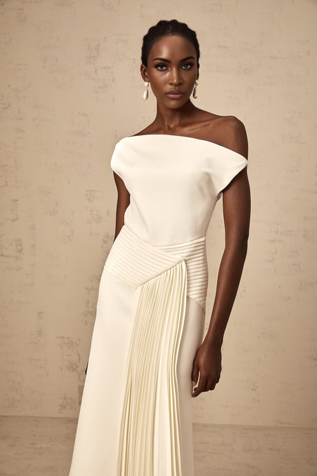 A white asymmetric midi dress with draped fabric details featuring a flowing silhouette and uneven hemline