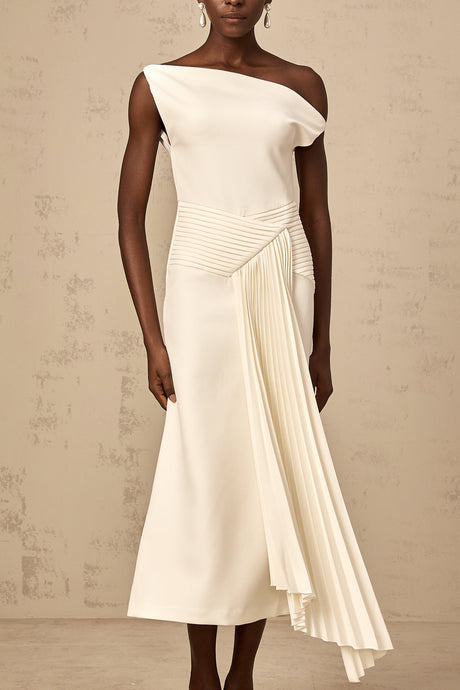 A white asymmetric midi dress with draped fabric details worn by a model standing against a plain background