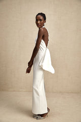 A white bandage dress with a large oversized bow detail named Capucine featuring a formfitting silhouette and elegant design