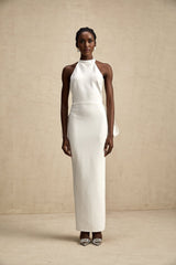 A white bandage dress with an oversized bow detail featuring a fitted silhouette and Capucine style design