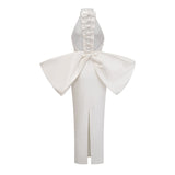 A white bandage dress with an oversized bow detail named Capucine featuring a formfitting silhouette and elegant design