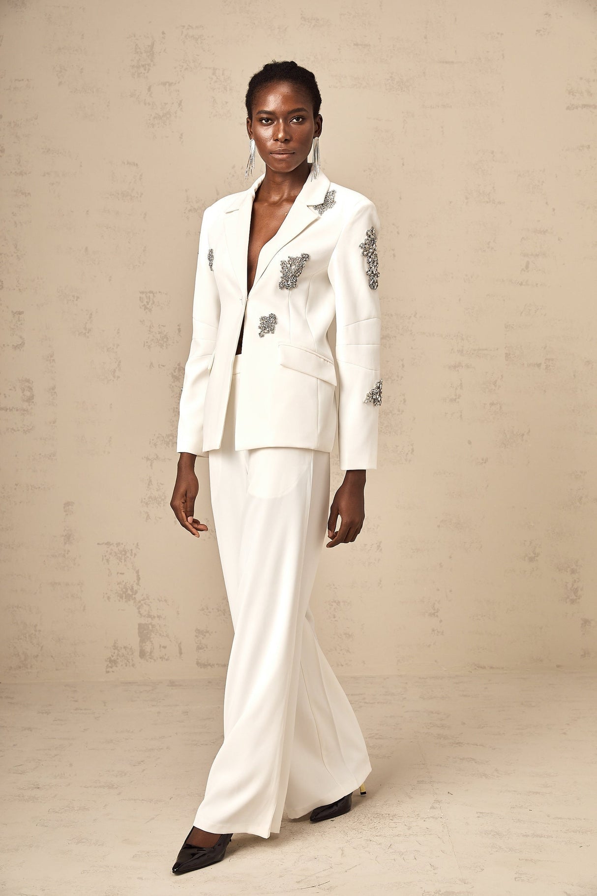 A white blazer and trouser set adorned with crystal embellishments named Edvige stylish formal attire for women